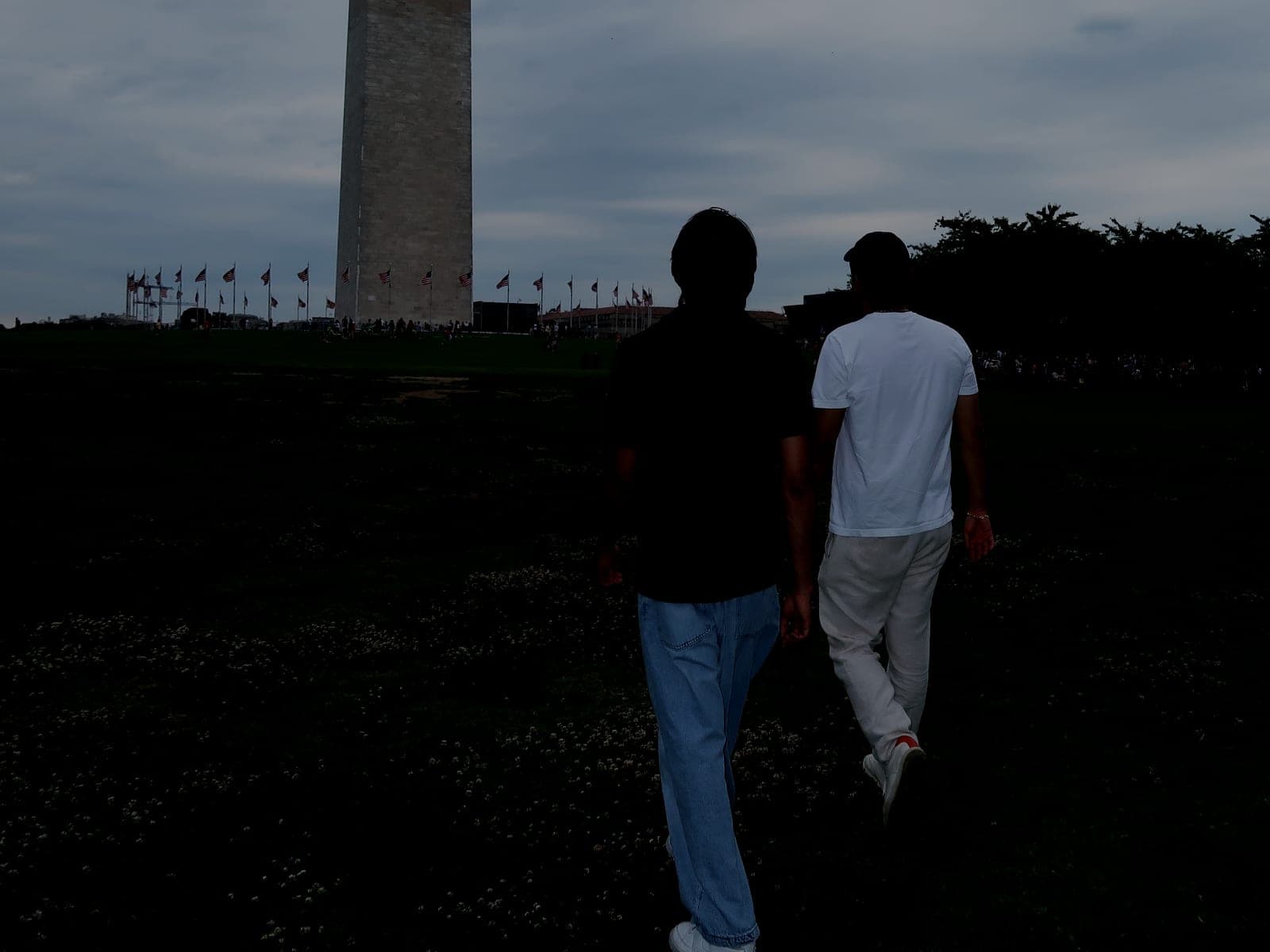 Jeffrey Escobar and Arshroop Saini walking toward the Washington Monument in Washington, DC