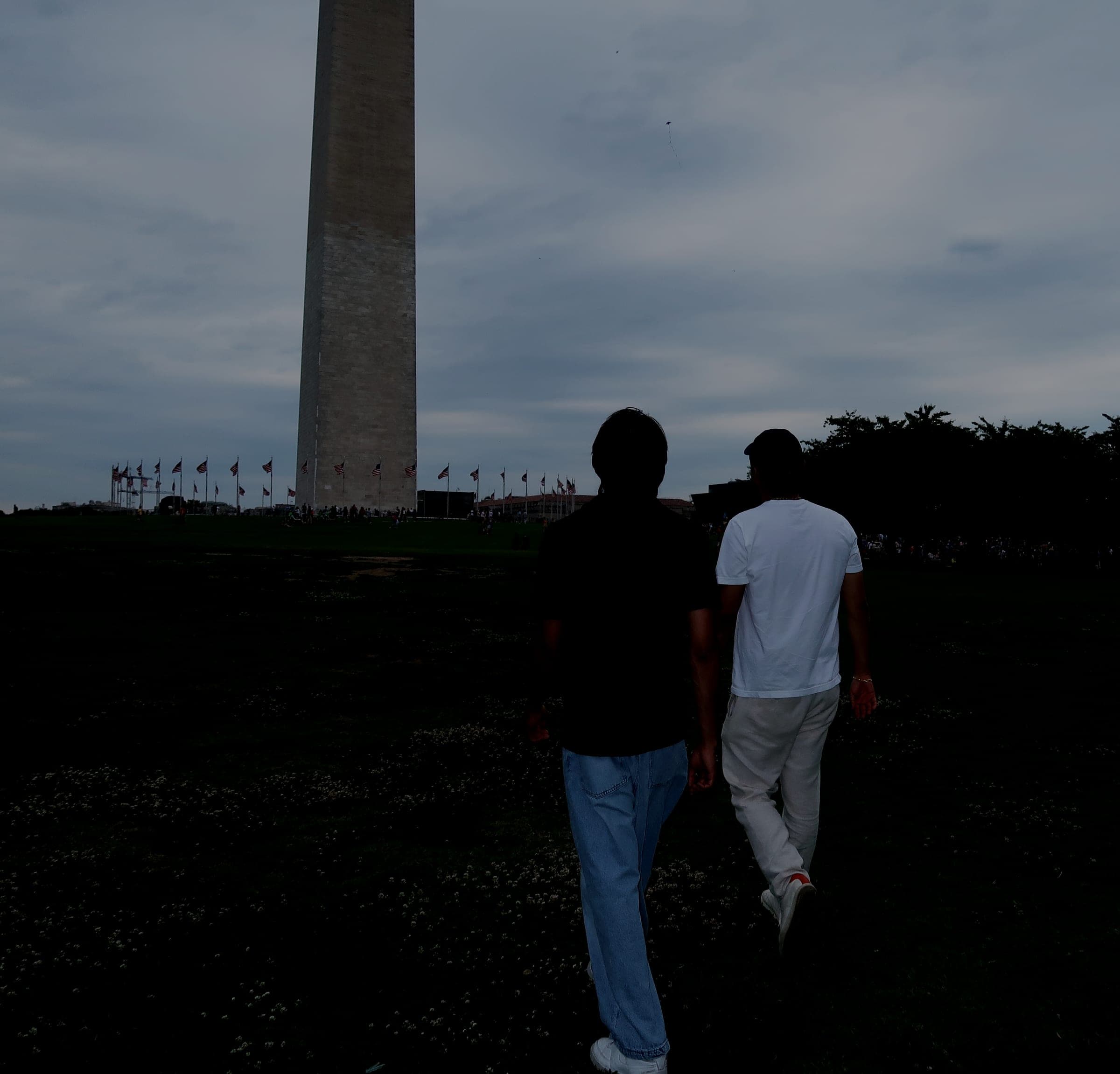 Jeffrey Escobar and Arshroop Saini walking toward the Washington Monument in Washington, DC
