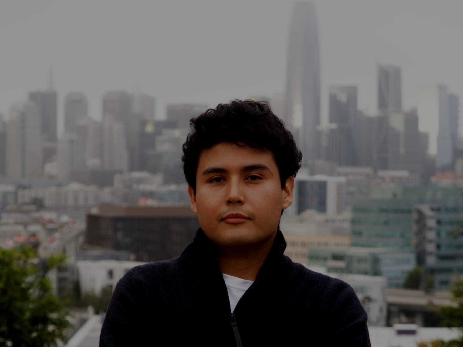 Jeffrey Escobar, founder and CTO of House AI, with the San Francisco skyline behind him