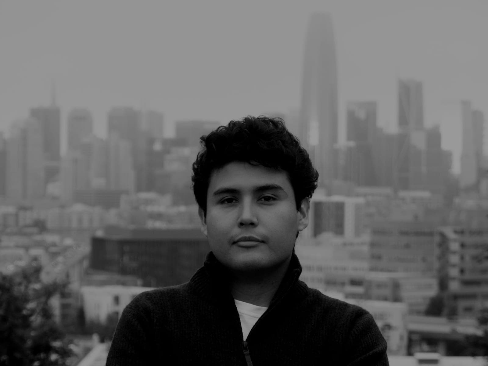 Black and white portrait of Jeffrey Escobar, founder and CTO of House AI, with the San Francisco skyline behind him