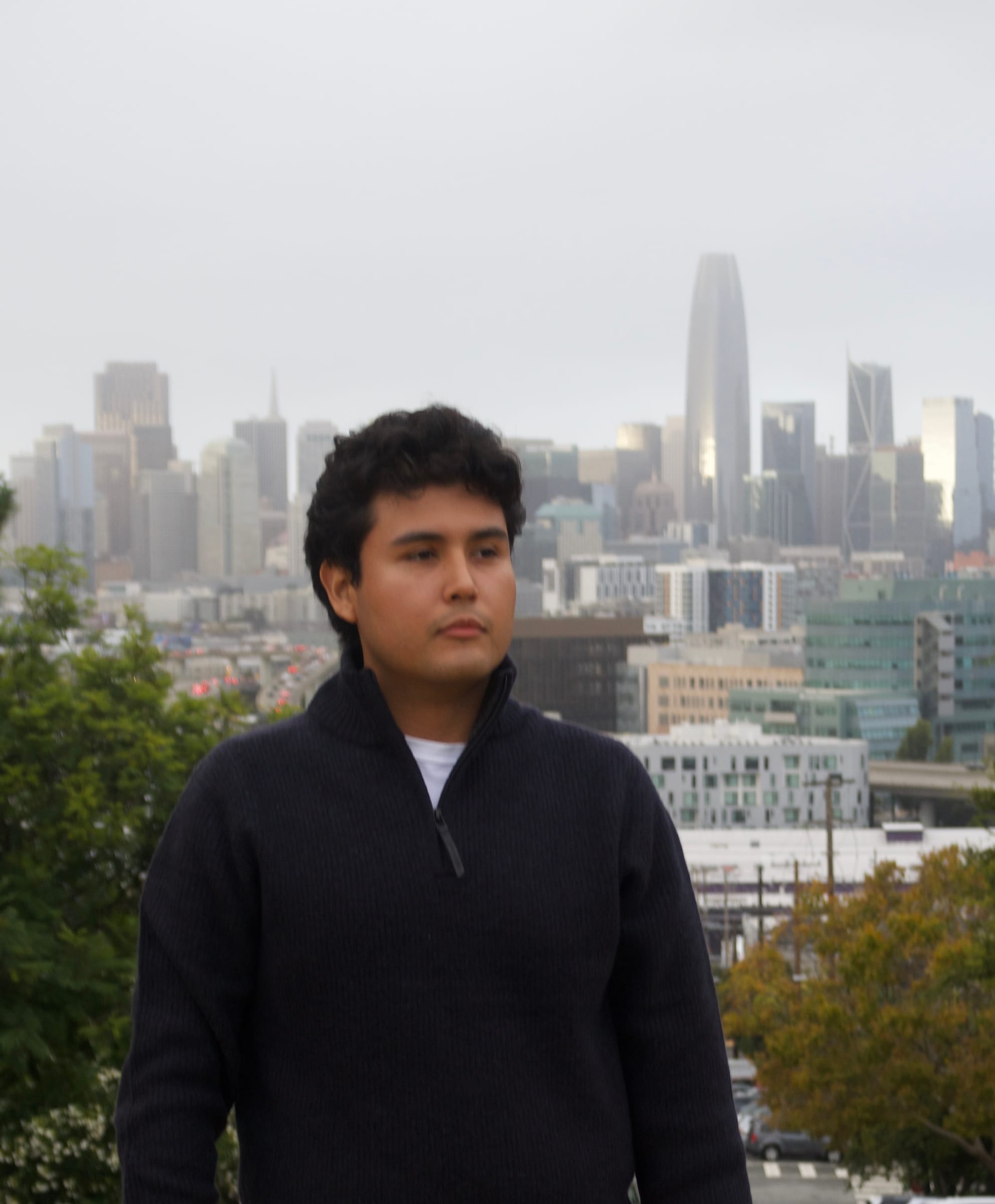 Jeffrey Escobar in San Francisco with the downtown skyline and Salesforce Tower behind him